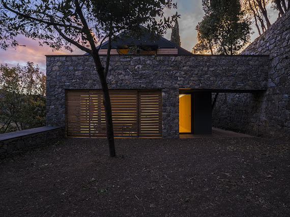 Casa Rufo — stone exterior at dusk with illuminated entrance