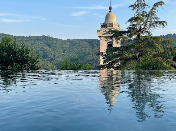 Village bell tower reflected in the infinity pool at Casa Rufo
